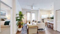 Located at 9105 Tredinick Pkwy in Jacksonville, FL, this single-story 2-bedroom, 2-bathroom home offers a thoughtfully designed open-concept floor plan. The welcoming entrance flows into a bright and airy living area featuring hardwood-style flooring, elevated ceilings, a ceiling fan, and large windows and glass doors that invite abundant natural light. The seamlessly connected dining and kitchen area is well-appointed with white shaker-style cabinetry, granite countertops, stainless steel appliances including a dishwasher and range, and a window above the sink for added brightness.

The primary bedroom is generously sized, featuring plush carpet flooring, soaring ceilings, and a dedicated walk-in closet. The second bedroom also offers carpeted flooring and ample space. Both bathrooms are finished with granite-topped vanities, white cabinetry, hardwood-style tile flooring, and tub-shower combinations with tiled surrounds and natural window light. Each bathroom includes dedicated closet storage, contributing to practical everyday living.

Throughout the home, a clean, neutral color palette and modern finishes create a cohesive and inviting atmosphere, making this Jacksonville residence a comfortable and functional living space.