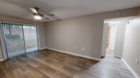 Located at 500 Manor View Dr in Knoxville, Tennessee, this well-appointed one-bedroom, one-bathroom home offers a thoughtfully designed single-floor layout. The living room is bright and welcoming, featuring wood-look plank flooring, neutral taupe walls, white baseboards, and a ceiling fan with light. A sliding glass door dressed with vertical blinds floods the space with natural light and provides a view of the surrounding greenery outside. The layout flows seamlessly into the kitchen, which is finished with crisp white shaker-style cabinetry, granite countertops with speckled detailing, a stainless steel sink with a modern pull-down faucet, and a dedicated pantry for added storage. The spacious primary bedroom is carpeted for comfort, features a ceiling fan, and offers generous storage with two side-by-side double-door closets. The bathroom is clean and functional, showcasing matching granite countertops on the vanity with white cabinetry, wood-look tile flooring, and a full tub-shower combination with tile surround. Throughout the home, a consistent neutral color palette and modern finishes create a cohesive, move-in-ready atmosphere.