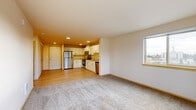 Located at 8104 Beverly Ln in Everett, Washington, this well-appointed one-bedroom, one-bathroom residence offers a thoughtfully designed layout across a single floor. The open-concept living and kitchen area creates a seamless flow, with light hardwood-style flooring in the kitchen transitioning to plush wall-to-wall carpeting in the living room. Large windows flood the living area with natural light and frame picturesque views of the surrounding Pacific Northwest evergreen tree canopy.

The kitchen is a standout feature, equipped with crisp white cabinetry, light countertops, and a full suite of stainless steel appliances including a refrigerator, range, microwave, and dishwasher. Recessed lighting enhances the bright, modern aesthetic throughout the space.

The bedroom offers a comfortable, carpeted retreat with a generous closet and a large window that continues the theme of natural light and outdoor views. The bathroom includes a full soaking tub and shower combination with clean, neutral finishes.

A hallway connects the rooms efficiently, adding to the functional design of the layout. The unit's neutral color palette and modern fixtures create a clean, move-in-ready environment suited for comfortable everyday living in Everett, WA.