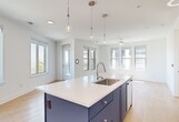 This contemporary 780 square foot apartment in Austin, Texas offers a thoughtfully designed living space. The open-concept layout seamlessly integrates the kitchen, living, and dining areas, creating a spacious feel. The kitchen boasts sleek blue cabinetry, contrasting beautifully with stainless steel appliances and light countertops. Throughout the apartment, warm wood-tone flooring adds a touch of natural elegance.

The generously sized 160 square foot primary bedroom features large windows that flood the space with natural light, while ceiling fans ensure comfort. The bathroom showcases a modern aesthetic with a navy blue vanity and ample storage. A walk-in closet provides excellent organization options.

Multiple windows throughout the apartment offer picturesque views and create a bright, airy ambiance. The unit also includes a private balcony, perfect for enjoying outdoor relaxation. Energy-efficient fixtures and appliances are incorporated throughout, reflecting a commitment to modern, sustainable living.

This well-appointed apartment combines style and functionality, making it an ideal urban retreat in the heart of Austin.