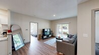 Located at 1600 Kitty Hawk Dr in Columbia, MO, this 2-bedroom, 2-bathroom unit offers a practical and comfortable single-floor layout designed for everyday living. The open-concept living area is anchored by a large sliding glass door that fills the space with natural light and provides views of the surrounding greenery, creating a welcoming atmosphere. Wood-look flooring runs consistently throughout the unit, lending a cohesive, clean aesthetic.

The kitchen is well-appointed with white shaker cabinetry, granite-style countertops, and a full suite of stainless steel appliances including a range, over-the-range microwave, and refrigerator. A dedicated laundry room is conveniently accessible directly from the kitchen and houses a full-size washer and dryer.

Both bedrooms are comfortably sized, each equipped with ceiling fans and light-toned walls that contribute to a calm, restful environment. The generously sized primary bedroom features a window with outdoor views, while both rooms benefit from easy closet access. The two bathrooms include tub/shower combinations with built-in shelving niches for added functionality. The unit's straightforward, efficient design makes it a well-rounded living space in a residential Columbia neighborhood.