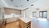 This contemporary 1000 square foot apartment in Atlanta offers a harmonious blend of style and functionality. The open-concept design seamlessly integrates the living room and kitchen, creating an expansive feel. Large windows flood the space with natural light, offering stunning city views and enhancing the sense of spaciousness.

The gourmet kitchen is a chef's dream, featuring sleek light wood cabinetry, stainless steel appliances, and a generous island with quartz countertops. Modern lighting fixtures, including a striking linear pendant over the island, add a touch of sophistication.

Both bedrooms are generously sized, with the primary bedroom boasting 140 square feet. The bathrooms showcase modern design with floating vanities, large mirrors, and spacious walk-in closets. High-quality finishes are evident throughout, from the warm hardwood floors to the crisp white walls.

Additional features include a balcony accessible from the living area, recessed lighting, and ceiling fans for comfort. The apartment's layout efficiently utilizes every square foot, with cleverly designed storage solutions in the closets and kitchen.

Located in a prime Atlanta location, this apartment combines urban living with thoughtful design, making it an ideal home for those seeking a contemporary lifestyle in the heart of the city.