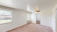 Located at 275 North Ave in Washington, PA, this two-bedroom, one-bathroom single-floor residence offers a practical and well-organized layout. The space features neutral white walls throughout, creating a clean and bright atmosphere that is complemented by natural light streaming through multiple windows in each room.

The primary bedroom is notably spacious, featuring soft wall-to-wall carpeting, a ceiling fan with light fixture, a classic radiator heater beneath the window, and ample room for furnishings. The second bedroom also offers carpeted flooring, a ceiling fan, radiator heating, and two windows that bring in generous natural light, along with closet access. Both bedrooms connect through hallways that help define the flow of the unit.

The kitchen is fitted with wood-toned cabinetry, a sink, and durable wood-look vinyl plank flooring, providing a functional cooking and prep space. The bathroom includes a combined tub and shower unit with built-in shelving, a window for ventilation and natural light, and a clean, all-white finish.

Throughout the residence, the consistent use of neutral tones, carpet in living and sleeping areas, and classic architectural details lend the space a straightforward, livable character well-suited for comfortable everyday living.