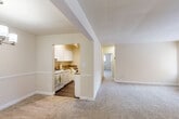 Located at 641 Sligo Ave in Silver Spring, MD, this well-appointed two-bedroom, one-bathroom residence offers a functional and comfortable single-floor layout. The open-plan living and dining area is generously sized, featuring warm neutral-toned carpeting, soft cream walls with a chair-rail detail, and natural light from large windows. A chandelier accent marks the dining area, adding a touch of elegance to the combined space.

The kitchen is efficiently designed with white shaker-style cabinetry, granite countertops, hardwood-style flooring, and a full suite of white appliances including a gas range, dishwasher, and refrigerator. Notably, an in-unit washer is integrated into the kitchen space, providing added convenience.

Both bedrooms are carpeted and feature neutral walls, windows with natural light, and ample closet storage — including bifold closet doors in one bedroom. The spacious primary bedroom offers generous room to accommodate a full furniture arrangement. A hallway connects the bedrooms to the full bathroom, which includes a tub/shower combination, white vanity cabinetry, and hardwood-style flooring. Four closets throughout the unit ensure abundant storage. The overall aesthetic is clean, bright, and move-in ready.