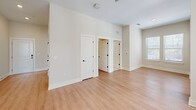 Located at 3801 Brody Dr in Greensboro, NC, this well-appointed single-story residence offers two bedrooms and two bathrooms within a thoughtfully designed open floor plan. Light wood-look flooring flows through the main living areas, complemented by neutral warm tones on the walls and clean white trim throughout.

The kitchen is a standout feature, outfitted with gray shaker-style cabinetry, sleek marble-look quartz countertops, a subway tile backsplash, a stainless steel undermount sink with a matte black faucet, and a full suite of stainless steel appliances. Natural light pours in through multiple windows fitted with white wood blinds, creating a bright and functional workspace.

The living room connects seamlessly to the kitchen and features wide-plank flooring, a ceiling fan, and access to an exterior door, allowing for an abundance of natural light. Both bedrooms are carpeted and well-sized, with ceiling fans, ample natural light from large windows, and dedicated closets.

The bathrooms are finished to a high standard, each featuring gray vanity cabinetry, granite-look countertops, matte black hardware and fixtures, and wood-look flooring. One bathroom includes a full soaking tub with tiled surround, while the other provides walk-in closet access. The overall design is cohesive, modern, and move-in ready.