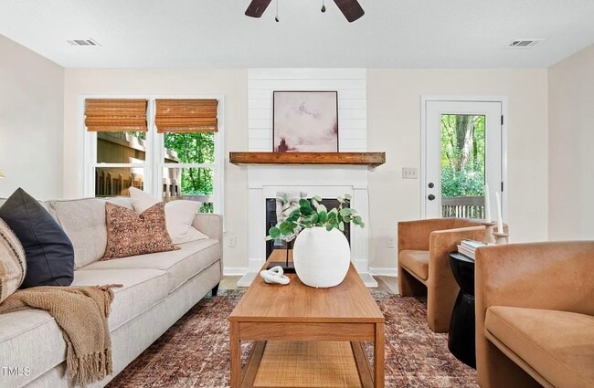 Spacious living area surrounded by private trees. Real fireplace. - 115 Inverness Ct