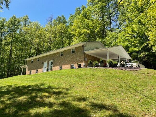 OUTSIDE FRONT WITH CARPORT - 1809 Winding Hills Dr