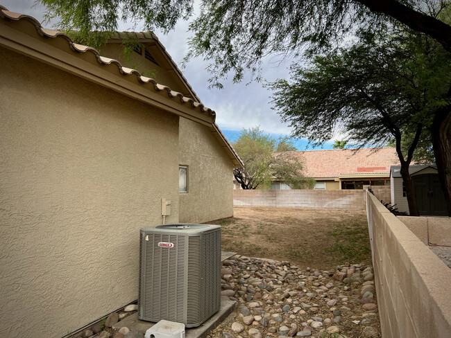 Side yard on West side of home - not pictured is pea gravel added 2022 - 8959 N Veridian Dr