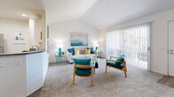 Located at 655 Baker St in Costa Mesa, California, this well-appointed one-bedroom, one-bathroom residence offers a thoughtfully designed layout across a single floor. The living room serves as the centerpiece of the home, showcasing dramatic vaulted ceilings that amplify the sense of space and airiness. Soft carpeting, large sliding glass doors with vertical blinds, and direct access to a private outdoor patio flood the area with natural light and provide a seamless indoor-outdoor connection. The open-concept design allows the living area to flow naturally into the dining space and kitchen. The kitchen features white cabinetry, granite-style countertops, stainless steel appliances including a refrigerator, range, and microwave, and durable wood-look flooring, offering both style and functionality. The spacious primary bedroom is a comfortable retreat, complete with plush carpeting, a walk-in closet, and a bright window framing outdoor greenery. The full bathroom includes a combined tub and shower with clean, white finishes. A dedicated closet adds practical storage to round out this efficient and inviting Costa Mesa residence.