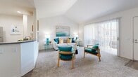 Located at 655 Baker St in Costa Mesa, California, this well-appointed one-bedroom, one-bathroom residence offers a thoughtfully designed layout across a single floor. The living room serves as the centerpiece of the home, showcasing dramatic vaulted ceilings that amplify the sense of space and airiness. Soft carpeting, large sliding glass doors with vertical blinds, and direct access to a private outdoor patio flood the area with natural light and provide a seamless indoor-outdoor connection. The open-concept design allows the living area to flow naturally into the dining space and kitchen. The kitchen features white cabinetry, granite-style countertops, stainless steel appliances including a refrigerator, range, and microwave, and durable wood-look flooring, offering both style and functionality. The spacious primary bedroom is a comfortable retreat, complete with plush carpeting, a walk-in closet, and a bright window framing outdoor greenery. The full bathroom includes a combined tub and shower with clean, white finishes. A dedicated closet adds practical storage to round out this efficient and inviting Costa Mesa residence.