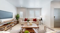 This well-designed two-floor residence offers a cohesive blend of modern aesthetics and functional living spaces, finished with a consistent neutral palette that creates a bright, welcoming atmosphere throughout.

The main living area is anchored by light hardwood-style flooring and recessed lighting, with multiple windows dressed in white horizontal blinds that allow generous natural light to fill the room. The open layout comfortably accommodates both a seating arrangement and an entertainment setup, with a media console and ample space for relaxing or entertaining.

The kitchen features flat-front cabinetry in a warm wood-tone finish paired with white quartz countertops, a stainless steel undermount sink with a modern gooseneck faucet, and full stainless steel appliances including a large side-by-side refrigerator with an in-door ice and water dispenser. Light hardwood-style flooring continues seamlessly through this space.

The bedrooms are carpeted for comfort and each benefits from multiple windows that bring in natural light. Both rooms offer a calm, restful atmosphere with neutral wall tones and clean lines.

The bathrooms mirror the kitchen's design language, featuring the same warm wood-tone cabinetry, white quartz countertops, undermount sinks, and light wood-look flooring, creating a unified and polished look across the home.