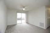 This single-floor residence offers a well-organized layout with a variety of functional living spaces. The living area is generously sized, featuring plush wall-to-wall carpeting, a ceiling fan with integrated lighting, and a sliding glass door fitted with vertical blinds that invites natural light while providing access to the exterior. The galley-style kitchen is efficiently arranged with warm wood-toned cabinetry, light countertops, a stainless steel sink, and white appliances including an electric range and refrigerator. A walk-in pantry closet offers additional storage directly off the kitchen. The kitchen opens via a peninsula counter to the main living area, creating an open and connected feel.

The bedrooms are carpeted and bright, each equipped with a ceiling fan and windows dressed with horizontal blinds. One bedroom features a dedicated walk-in closet and direct access to a full bathroom, while additional closets throughout provide practical storage solutions. The bathrooms are finished with neutral tile flooring, a vanity with integrated sink, a toilet, and a full bathtub with shower. Clean white walls and consistent neutral tones throughout the space lend a cohesive, move-in-ready aesthetic ideal for comfortable everyday living.