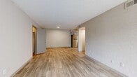 Located at 2411 Pulaski Highway in Columbia, TN, this 2-bedroom, 1-bathroom unit offers a well-organized single-floor layout designed for comfortable everyday living. Light wood-style flooring runs throughout the home, complementing the neutral wall tones and textured ceilings that give each room a clean, cohesive feel.

The two living areas provide flexible space for both relaxing and entertaining. One features a sliding glass door with vertical blinds that floods the room with natural light and opens to an outdoor view, while the other connects directly to the kitchen, creating an open and functional flow. The kitchen is a standout feature, outfitted with gray shaker-style cabinetry, granite countertops, and a full suite of stainless steel appliances including a refrigerator, dishwasher, electric range, and over-the-range microwave.

Both bedrooms are comfortably sized with natural light provided by windows fitted with blinds. The primary bedroom includes a dedicated closet with built-in shelving and hanging rods. A hallway connects the bedrooms to the shared full bathroom, which features large-format tile surrounds in the tub/shower combination, offering a clean and modern aesthetic throughout.