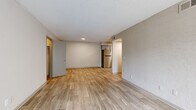 Located at 2411 Pulaski Highway in Columbia, TN, this 2-bedroom, 1-bathroom unit offers a well-organized single-floor layout designed for comfortable everyday living. Light wood-style flooring runs throughout the home, complementing the neutral wall tones and textured ceilings that give each room a clean, cohesive feel.

The two living areas provide flexible space for both relaxing and entertaining. One features a sliding glass door with vertical blinds that floods the room with natural light and opens to an outdoor view, while the other connects directly to the kitchen, creating an open and functional flow. The kitchen is a standout feature, outfitted with gray shaker-style cabinetry, granite countertops, and a full suite of stainless steel appliances including a refrigerator, dishwasher, electric range, and over-the-range microwave.

Both bedrooms are comfortably sized with natural light provided by windows fitted with blinds. The primary bedroom includes a dedicated closet with built-in shelving and hanging rods. A hallway connects the bedrooms to the shared full bathroom, which features large-format tile surrounds in the tub/shower combination, offering a clean and modern aesthetic throughout.