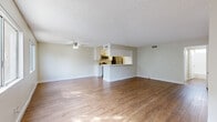 Located on Walnut St in Santa Clarita, CA, this single-story 1-bedroom, 2-bathroom unit offers a well-organized layout with warm, wood-look flooring throughout. The open-concept living and dining area is bright and spacious, filled with natural light from large windows and finished with a textured ceiling and a ceiling fan overhead. A pass-through counter seamlessly connects this space to the kitchen, enhancing the open feel.

The galley-style kitchen is efficiently designed, featuring white cabinetry with brushed nickel hardware, white quartz-style countertops, and a full suite of stainless steel appliances including a refrigerator, electric range, and over-the-range microwave. A dedicated dining area sits just adjacent, creating a natural flow between the kitchen and living spaces.

A hallway leads to the generously sized bedroom, which features a large window that brings in natural light, a textured ceiling, and its own closet. The unit is well-appointed with six closets throughout, providing ample storage. Both bathrooms are clean and functional, with wood-look flooring, white fixtures, and one featuring a full tub/shower combination with a window for ventilation. The overall aesthetic is clean, bright, and move-in ready.
