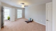 This single-story residence at 22B offers a well-organized layout with a variety of functional spaces throughout. The living area is anchored by a fireplace, creating a welcoming focal point, and is finished with neutral-toned walls that lend a clean, cohesive aesthetic throughout the home.

The bedrooms are carpeted and generously proportioned, each equipped with ceiling fans for year-round comfort. Natural light enters through windows with outdoor views of surrounding greenery. At least one bedroom features a dedicated walk-in closet with built-in shelving, offering practical storage.

The kitchen is outfitted with warm wood-toned cabinetry, granite-style countertops, and stainless steel appliances including an electric range with a built-in microwave above. Adjacent to the kitchen is a dedicated laundry closet housing a full-size washer and dryer, adding everyday convenience. The flooring in the kitchen and laundry area is durable wood-style plank flooring.

Two full bathrooms serve the residence, each featuring a tub-shower combination. One bathroom includes wood-style plank flooring and a vanity with dark cabinetry, while the other is finished with tile flooring and neutral walls. Together, the spaces offer a practical and comfortable living environment.
