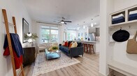 Located at 12221 Gregg Manor Rd in Manor, TX, this well-appointed 2-bedroom, 2-bathroom single-story residence offers a bright, contemporary living experience. The open-concept main area seamlessly connects the living room, dining area, and kitchen, all finished with light wood-look flooring and crisp white walls. The living room features large windows that flood the space with natural light and a ceiling fan overhead, with direct access to a private balcony. The dining area is defined by generous windows with outdoor views, creating an airy atmosphere. The kitchen is a standout, boasting a large granite-topped island with bar seating, sleek gray cabinetry, stainless steel appliances, a tile backsplash, pendant lighting, and a pantry for added storage. The primary bedroom is a comfortable retreat with multiple windows, a ceiling fan, and ample closet space. Both bathrooms are finished with granite countertops, wood-toned cabinetry, and light tile flooring — one featuring a glass-enclosed walk-in shower and the other a full soaking tub. Additional highlights include an in-unit laundry area and four closets throughout, ensuring practical storage. The overall ambiance is clean, modern, and welcoming.