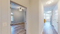 This single-floor residence offers a well-designed open-concept layout that seamlessly connects the living, dining, and kitchen areas. The space is immediately distinguished by its dramatic arched windows, which line the main living area and flood the interior with natural light while framing sweeping urban views of the surrounding cityscape. Hardwood-style flooring flows consistently throughout the main living spaces, lending warmth and visual continuity.

The kitchen is a functional centerpiece, featuring warm-toned wood cabinetry, dark granite-style countertops, stainless steel appliances including a refrigerator, electric range, and built-in microwave, as well as a peninsula with pendant lighting overhead. A dedicated sink area with additional counter space enhances the kitchen's practicality.

The bedroom is finished in soft, neutral tones with a ceiling fan and a generously sized closet with wire shelving. The bathroom includes a full tub and shower combination, a wood-toned vanity with a light countertop, and tile flooring.

Throughout the unit, clean white millwork, panel-style doors, and a neutral color palette create a cohesive and move-in-ready aesthetic. The abundance of windows ensures a bright, airy atmosphere across every room.