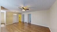 Located at 200 Mount Rushmore Dr in Richmond, Kentucky, this single-story, three-bedroom, one-bathroom home offers a practical and comfortable layout. The living room is a bright, open space featuring warm hardwood-style flooring, a textured ceiling, and a ceiling fan with a light fixture. Natural light filters in through a window near the front entry door, creating a welcoming atmosphere. An elegant chandelier marks the transition into the kitchen and dining area.

The kitchen is efficiently designed, equipped with warm wood cabinetry, laminate countertops, a double stainless steel sink, a black electric range, and a full-size black refrigerator. A window above the sink allows for natural light to brighten the workspace.

The three bedrooms are carpeted for comfort and finished with neutral, light-toned walls. The spacious primary bedroom includes a ceiling fan with lighting, while the additional bedrooms feature standard overhead lighting and windows with blinds. One bedroom also includes a closet. The bathroom features hardwood-style flooring and is cleanly appointed with essential fixtures.

Throughout the home, textured ceilings, neutral paint tones, and consistent trim work provide a cohesive and tidy aesthetic, making this a functional and move-in ready residence.