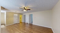 Located at 200 Mount Rushmore Dr in Richmond, Kentucky, this single-story, three-bedroom, one-bathroom home offers a practical and comfortable layout. The living room is a bright, open space featuring warm hardwood-style flooring, a textured ceiling, and a ceiling fan with a light fixture. Natural light filters in through a window near the front entry door, creating a welcoming atmosphere. An elegant chandelier marks the transition into the kitchen and dining area.

The kitchen is efficiently designed, equipped with warm wood cabinetry, laminate countertops, a double stainless steel sink, a black electric range, and a full-size black refrigerator. A window above the sink allows for natural light to brighten the workspace.

The three bedrooms are carpeted for comfort and finished with neutral, light-toned walls. The spacious primary bedroom includes a ceiling fan with lighting, while the additional bedrooms feature standard overhead lighting and windows with blinds. One bedroom also includes a closet. The bathroom features hardwood-style flooring and is cleanly appointed with essential fixtures.

Throughout the home, textured ceilings, neutral paint tones, and consistent trim work provide a cohesive and tidy aesthetic, making this a functional and move-in ready residence.