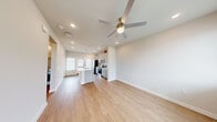 Located on Tigers Eye Way in Fort Worth, TX, this single-story, one-bedroom, one-bathroom home offers a well-designed layout that maximizes every square foot. The open-concept living and kitchen area forms the heart of the home, finished with light wood-look flooring and neutral tones that create a clean, modern atmosphere. A ceiling fan with a brushed gold fixture anchors the living space, while recessed lighting ensures consistent illumination throughout.

The kitchen is a standout feature, equipped with gray shaker-style cabinetry, a white subway tile backsplash, stainless steel appliances — including a side-by-side refrigerator, electric range, and built-in microwave — and a central island with a sink and pendant lighting above. A window at the far end of the kitchen invites natural light into the space.

The bedroom is a comfortable retreat featuring wood-look flooring, a ceiling fan, and a window with exterior views. The full bathroom includes a single-sink vanity with a white countertop, a tiled soaking tub and shower combination, and a window for natural light. A dedicated laundry area accommodates a full-size front-loading washer and dryer. A closet and utility room complete the functional layout of this tidy, move-in-ready home.