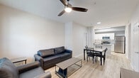 Located at 1805 Loftway Cir in Orlando, FL, this well-designed 2-bedroom, 2-bathroom single-floor unit offers a clean, contemporary layout with efficient use of space. The open-concept living, dining, and kitchen area serves as the heart of the home, featuring light wood-look flooring, neutral walls, and ceiling fans that keep the space bright and airy. The living area accommodates comfortable seating and flows seamlessly into the dining space, with a large window at the front that fills the room with natural light.

The kitchen is appointed with white shaker-style cabinetry, gray countertops, a hexagonal tile backsplash, and a full suite of stainless steel appliances, including a range, microwave, refrigerator, and dishwasher. A hallway connects the main living area to the two bedrooms and bathrooms, with three closets and a dedicated laundry and utility room providing ample storage. Both bedrooms feature carpet flooring, ceiling fans, and windows with natural light. The two bathrooms are finished with white cabinetry, gray countertops, and light flooring — one featuring a walk-in shower and the other a full tub-shower combination with clean white tile.