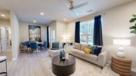 This single-story residence in Vallejo, California, presents a well-designed layout with modern finishes throughout. The open-concept living area features light wood-style flooring, recessed lighting, and a ceiling fan, creating a bright and comfortable atmosphere. Large windows dressed with navy curtains invite natural light while offering views of the surrounding area.

The living space flows seamlessly into a dedicated dining area, which features recessed lighting and direct access to additional rooms. The kitchen is equipped with dark espresso cabinetry, stainless steel appliances including a refrigerator, range, and over-the-range microwave, a white subway tile backsplash, and a peninsula with pendant lighting and bar seating — ideal for casual dining or entertaining.

The bedroom is carpeted and generously sized, featuring a ceiling fan, ample natural light from a large window, and direct access to a spacious walk-in closet outfitted with wire shelving systems for organized storage. The bathroom includes dark wood cabinetry with a gray countertop, an undermount sink, a framed mirror, and light wood-style flooring, completing the home's cohesive, contemporary aesthetic.