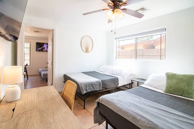 Bedroom with study area and 65" Roku TV - 5901 W Cypress St