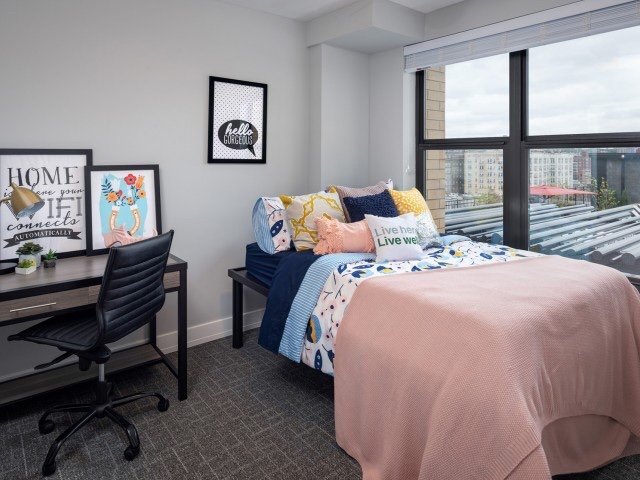 Furnished room with XL bed, table, chair and wardrobe shelves - 4501 Centre Ave