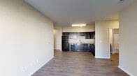 Located at 1700 Herbert Ave in Louisville, KY, this single-floor residential unit offers a practical and modern layout designed for comfortable everyday living. The open-concept living and kitchen area is anchored by durable wood-look flooring that extends throughout the main living spaces, creating a clean and cohesive aesthetic. The kitchen is well-equipped with dark espresso cabinetry reaching toward the ceiling, light granite-style countertops, a stainless steel sink, and a full suite of black appliances including a refrigerator, dishwasher, and range. A range hood and recessed lighting complete the functional cooking space. The bedrooms feature plush carpeting, neutral-toned walls, and windows with blinds that allow for natural light while maintaining privacy. Two bathrooms serve the unit — one featuring a soaking tub and vanity with dark cabinetry and a granite-style countertop, and the other offering a standalone walk-in shower, toilet, and matching vanity. The overall ambiance throughout the unit is clean and contemporary, with neutral warm tones, white trim, and a straightforward floor plan that maximizes usable space.