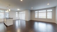 Located at 3107 Detroit Ave in Cleveland's vibrant Ohio City neighborhood, this single-floor residence offers a clean, contemporary design throughout. The open-concept living area is expansive and bright, featuring rich dark hardwood flooring, recessed lighting, and large windows with vertical blinds that allow generous natural light to fill the space. The modern kitchen is a standout feature, equipped with high-gloss white cabinetry extending to the ceiling, dark granite countertops, a subway tile backsplash, stainless steel appliances, and a central island with pendant lighting overhead — ideal for both cooking and entertaining. The bedrooms are finished with plush carpeting and offer ample closet space, including a walk-in closet in the primary bedroom. Natural light continues into the bedrooms through well-placed windows with exterior views. The unit includes two bathrooms: a full bathroom with a soaking tub and shower combo, white cabinetry, and a dark granite vanity top, and a second bathroom featuring a glass-enclosed walk-in shower, matching cabinetry, and tile flooring. Throughout the unit, a consistent neutral color palette, clean lines, and modern finishes create a cohesive and contemporary living environment.