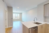 Located at 3043–3059 Lawrence Expy in Santa Clara, CA, this single-floor unit offers a thoughtfully designed layout that maximizes its compact footprint. The open-concept living and kitchen area creates a seamless flow, anchored by a sleek kitchen peninsula with a crisp white quartz countertop and an undermount stainless steel sink. Light wood-toned cabinetry extends floor-to-ceiling, providing generous storage, while stainless steel appliances—including a refrigerator with ice maker, gas range, built-in microwave, and dishwasher—add a polished, modern character. A tiled backsplash completes the kitchen's clean aesthetic.

Light wood-finish flooring runs consistently throughout, contributing to a warm, cohesive atmosphere. The living area receives ample natural light through large windows that frame elevated views of the surrounding Santa Clara streetscape and open sky. Additional rooms benefit from similarly sized windows, reinforcing the bright and airy ambiance with recessed lighting supplementing natural illumination.

The bathroom features a full soaking tub and shower combination, accented by white subway tile surround and chrome fixtures, maintaining the unit's consistent modern palette. Neutral gray walls throughout the space enhance the sense of openness, making this a well-appointed, contemporary unit in the heart of Silicon Valley.