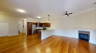Located at 665 Saratoga Rd in Gansevoort, NY, this single-floor, 3-bedroom, 3-bathroom home offers a thoughtfully designed layout with quality finishes throughout. The open-concept kitchen and living area serves as the heart of the home, featuring rich dark wood cabinetry, stainless steel appliances, granite countertops, and pendant lighting over a peninsula island. Warm hardwood flooring flows seamlessly through the main living area, which is brightened by a sliding glass door that brings in natural light and provides outdoor access. A ceiling fan adds comfort to both the living room and primary bedroom. The bedrooms are carpeted for warmth and comfort, with the spacious primary suite offering a ceiling fan and direct access to its own bathroom, which includes a large walk-in tiled shower with glass doors and a dark-vanity. Additional bedrooms are generously sized and feature panel-style doors and built-in closet storage. A dedicated closet with wire shelving provides practical storage. Crown molding and clean neutral tones throughout lend the home a polished, move-in-ready appearance. The bathrooms feature tile flooring and dark-finish vanities with granite countertops, maintaining a consistent, refined aesthetic across the home.