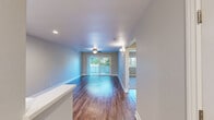 Located at 37950 Fremont Blvd in Fremont, CA, this single-floor, 2-bedroom, 1-bathroom home offers a well-organized layout with a seamless flow between its main living spaces. The open kitchen and living room area is a highlight of the home, featuring rich hardwood-style flooring, recessed lighting, and large sliding glass doors that fill the space with natural light and provide direct access to a private balcony overlooking lush greenery. A ceiling fan adds comfort to the living area.

The kitchen is thoughtfully updated with crisp white shaker-style cabinetry, light quartz countertops, a stainless steel appliance suite including a refrigerator, range, and microwave, and a dedicated sink area — all finished with the same wood-style flooring for a cohesive look.

Both bedrooms are carpeted for comfort and include ceiling fans. The primary bedroom is generously sized, featuring a wide window with views of the surrounding neighborhood and trees. The second bedroom is cozy and well-lit. A dedicated closet and hallway provide additional storage.

The full bathroom is clean and modern, appointed with white cabinetry, a large vanity mirror, wood-style flooring, and a full tub-shower combination with brushed nickel fixtures. The home's neutral color palette throughout creates a bright, welcoming ambiance.