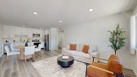 Located at 44150 35th St W in Lancaster, CA, this single-floor, 3-bedroom, 2-bathroom home offers a clean, modern aesthetic with thoughtful finishes throughout. The open-concept living and kitchen area serves as the heart of the home, featuring light wood-look flooring, recessed lighting, and crisp white walls that create a bright, airy atmosphere. The kitchen is well-appointed with white shaker cabinetry, stainless steel appliances including a refrigerator, range, microwave, and dishwasher, complemented by a stainless sink and ample counter space. A dedicated dining area flows naturally from the kitchen. The living area offers a comfortable, welcoming layout with a window providing natural light and views of the outdoors. Three bedrooms are finished with the same light wood flooring and neutral white walls, offering versatile, move-in-ready spaces. Each bedroom includes closet storage. The two bathrooms feature full tub-shower combinations with clean white surrounds, vanities, and wood-look flooring. A hallway connects the rooms efficiently, and a balcony provides an outdoor retreat. The overall design is modern and minimalist, ideal for those seeking a well-maintained, functional home in Lancaster.
