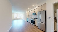 Located at 549 S Harvard Blvd in the heart of Los Angeles, this modern 2-bedroom, 1-bathroom unit offers a clean, contemporary design across a single floor. Wood-style plank flooring runs throughout, lending warmth and continuity to every room. The open kitchen and living area form the heart of the home, where light-toned cabinetry, white quartz countertops, a subway tile backsplash, and a full suite of stainless steel appliances — including a gas range, dishwasher, microwave, and refrigerator — create a stylish and functional cooking space. An in-unit stacked washer and dryer adds everyday convenience. The living area benefits from a generous bank of large windows that flood the space with natural light and offer views of the surrounding neighborhood. Both bedrooms are well-proportioned, featuring crisp white walls, wood-style flooring, and ample closet space with sliding or hinged doors. The primary bedroom is a comfortable retreat with a dedicated closet. The bathroom is finished with a soaking tub, tiled shower surround, terrazzo-style flooring, and a light wood vanity. Throughout, the clean lines, neutral palette, and modern finishes create a bright, move-in-ready living environment.