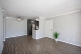 Located at 5636 Amaya Dr in La Mesa, California, this single-floor unit offers a well-organized layout that makes efficient use of its space. The open-concept living and dining areas are finished with wood-look laminate flooring and neutral gray walls, creating a clean and cohesive aesthetic. Crown molding adds a refined touch, while a ceiling fan provides practical comfort. A sliding glass door opens to an outdoor balcony, filling the living area with natural light and offering views of surrounding greenery.

The kitchen is thoughtfully appointed with dark wood-grain cabinetry, white quartz countertops, and a full suite of stainless steel appliances, including a refrigerator, range, microwave, and dishwasher. Wood-look tile flooring ties the kitchen seamlessly to the rest of the unit.

The bedrooms are carpeted for added comfort, each with windows featuring blinds and access to closet storage. The bathroom is finished with wood-look tile flooring, dark cabinetry, a white vanity countertop, and a shower-tub combination with a window above for natural light. A dedicated laundry area and a hallway connecting the main spaces complete the functional floor plan of this La Mesa residence.