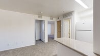 Located at 4415 S 28th St in Phoenix, Arizona, this 2-bedroom, 1-bathroom unit offers a practical and efficiently designed single-floor layout. The kitchen is equipped with light wood cabinetry, a white electric range, a full-size refrigerator, and a peninsula counter that provides additional workspace and separates the kitchen from the adjoining living area. Wood-look tile flooring anchors the kitchen, while soft carpet extends throughout the living space and bedrooms, creating a warm, cohesive feel.

The two bedrooms are thoughtfully sized, with the primary bedroom featuring a large sliding glass door fitted with vertical blinds that allow for generous natural light. The second bedroom also includes a window with vertical blinds and offers access to a utility closet housing the water heater. Both rooms are finished with neutral walls and plush carpet, providing a clean, move-in-ready canvas.

The bathroom is bright and functional, featuring a full tub-shower combination, a single-sink vanity with a light countertop and white cabinetry, and wood-look tile flooring that complements the kitchen. The overall aesthetic of the unit is clean and neutral, with white walls, standard ceiling height, and ample ventilation throughout. This unit is a straightforward, well-organized space suited for comfortable everyday living in Phoenix.