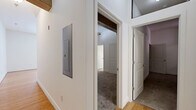 This 2-bedroom, 2-bathroom unit at 113-121 N 20th St, Unit 204 in Richmond, VA offers a well-designed single-floor layout with a blend of modern finishes and character-rich details. The open living room features warm hardwood flooring, bright white walls, and large windows that fill the space with natural light. It flows seamlessly into the kitchen and dining area, where a breakfast bar with pendant lighting, rich cherry wood cabinetry, granite countertops, and stainless steel appliances — including a range, microwave, and refrigerator — create a functional and attractive cooking space. The primary bedroom is a comfortable retreat highlighted by soaring ceilings with an exposed wood beam, adding architectural charm, along with plush carpeting and ample closet space. The second bedroom also features carpet flooring, a double-door closet with built-in shelving, and two windows that allow natural light. Both bathrooms are finished with tile flooring, full tub-shower combinations with white tile surrounds, and vanities with granite countertops. A dedicated utility room provides additional practicality. Throughout, the unit maintains a clean, neutral palette that offers a versatile canvas for personalization.
