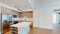 This contemporary 810 square foot apartment in Atlanta showcases a thoughtful blend of style and functionality. The open-concept layout maximizes the use of space, creating a seamless flow between the living areas. The kitchen is a standout feature, boasting modern cabinetry, stainless steel appliances, and a large island with built-in wine storage, perfect for entertaining or casual dining.

Floor-to-ceiling windows flood the space with natural light and offer panoramic views of the surrounding cityscape. The primary bedroom, measuring 130 square feet, provides ample space and includes a closet with built-in shelving for organized storage. The bathroom features clean lines and modern fixtures, maintaining the apartment's overall aesthetic.

Throughout the apartment, warm wood-toned flooring contrasts beautifully with the crisp white walls, creating a bright and inviting atmosphere. Recessed lighting and sleek ceiling fans add both functionality and style. The property's single floor layout ensures easy accessibility, while the thoughtful design makes the most of every square foot, resulting in a space that feels larger than its actual dimensions.