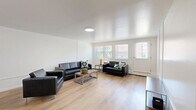 Located at 1231 S Allen Street in State College, PA, this 2-bedroom, 1-bathroom unit offers a well-organized single-floor layout designed for comfortable everyday living. The open-concept living room is bright and welcoming, featuring light wood-tone flooring, clean white walls, and multiple windows that invite natural light. The space is generously sized for seating arrangements and flows seamlessly into the rest of the unit. The kitchen is a standout feature, showcasing white upper cabinetry, gray lower cabinets, quartz countertops, and a peninsula with bar seating. Stainless steel appliances — including a range, microwave, and refrigerator — complete the modern, functional setup. The primary bedroom offers a comfortable footprint with a window for natural light, a ceiling light fixture, and an impressive wall of sliding closet doors providing ample storage. The bathroom features light blue subway tile surrounding a full soaking tub and shower combo, wood-tone flooring, and a white vanity. With five closets distributed throughout the unit, storage is abundant. A hallway connects the living spaces, and a private balcony adds an outdoor retreat. The consistent wood flooring and neutral palette create a cohesive, clean aesthetic throughout.
