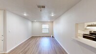 Located at 9606 E 71st St in Tulsa, Oklahoma, this single-floor, 2-bedroom, 2-bathroom residence offers a practical and well-organized layout. The living room is an open, light-filled space featuring light wood-style flooring, recessed lighting, and a textured ceiling. A passthrough opening connects seamlessly to the adjacent galley-style kitchen, which is fitted with white shaker cabinetry, light countertops, a stainless steel sink, and stainless steel appliances including a refrigerator, range, and dishwasher. Light tile flooring completes the kitchen's clean, functional aesthetic. The spacious primary bedroom features hardwood-style flooring, a ceiling fan with integrated lighting, and a window that allows natural light to fill the room. The second bedroom mirrors this design with matching flooring, recessed lighting, and its own window. Both bathrooms are finished in white with chrome fixtures — one features a walk-in shower enclosure, while the other includes a full tub-shower combination. Throughout the residence, neutral tones, clean lines, and consistent flooring choices create a cohesive and move-in-ready environment ideal for comfortable everyday living.