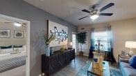 This single-story, one-bedroom, one-bathroom residence in Conroe, Texas offers a thoughtfully designed layout that maximizes every square foot. The open living area features wood-style flooring, neutral gray walls, and a ceiling fan with light fixture, creating a bright and comfortable atmosphere. Large windows with blinds and sheer curtains allow natural light to fill the space while offering views of the surrounding exterior.

The kitchen is outfitted with dark espresso cabinetry, granite-style countertops, a tile mosaic backsplash, a double-basin sink, and black appliances. A breakfast bar provides additional counter space and casual dining options. A cozy dining nook beside a window offers a charming spot for intimate meals.

The bedroom features plush carpeting, vaulted ceilings, a ceiling fan, and a walk-in closet, providing ample storage. A window allows natural light in, and direct access to the living area adds to the unit's functional flow.

The bathroom includes a tub-shower combination with large-format tile surround, wood-style flooring, and dark upper cabinetry. Throughout the residence, consistent neutral tones and modern finishes create a cohesive, contemporary aesthetic.