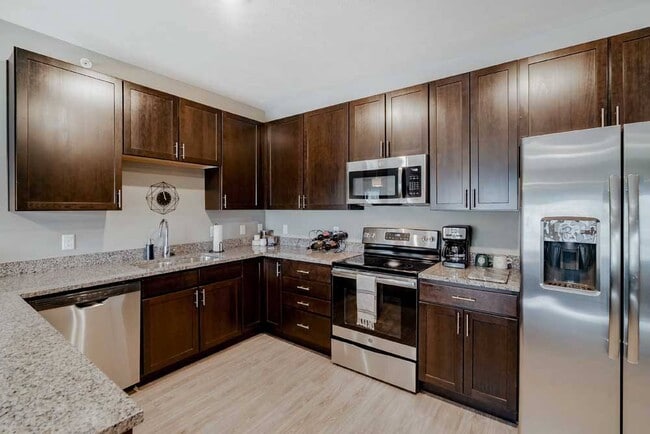 Cook with style in a kitchen that offers plenty of counter space in our 2-bedroom Magnolia. - WH Flats