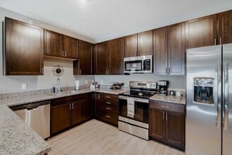 Cook with style in a kitchen that offers plenty of counter space in our 2-bedroom Magnolia. - WH Flats