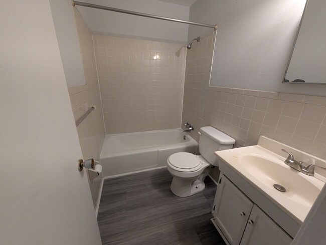 Full bathroom complete with shower/tub combo, vanity, and neutral finishes. - 1527 Brookbank Ave