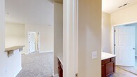 Located at 859 S Cliffs Cir in Spring Lake, NC, this single-floor, 2-bedroom, 2-bathroom home offers a practical and comfortable layout. The living area is spacious and bright, featuring plush carpeting, a ceiling fan, and French doors that invite natural light while opening to the outdoors. Neutral beige tones throughout the home create a clean, cohesive aesthetic.

The kitchen is well-appointed with warm wood cabinetry, granite-style countertops, a tile backsplash, and stainless steel appliances including a refrigerator, electric range, and built-in microwave. Tile flooring and a pendant light above the adjacent dining area add a polished touch.

The primary bedroom is generously sized, featuring carpet flooring, a ceiling fan, and a window with natural light. It connects to a bathroom with a wood vanity and a tub-shower combo. The second bedroom also features carpet, a ceiling fan, and a reach-in closet with built-in shelving. A second full bathroom mirrors the first in design and function.

A dedicated laundry room with washer and dryer hookups, wire shelving, and tile flooring adds convenience. The hallway, finished in hardwood-style flooring, connects the home's spaces efficiently, completing this well-organized and move-in-ready residence.
