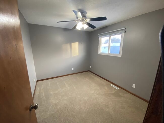 2nd bedroom upstairs with fresh paint and new carpet. - 6387 15th St N