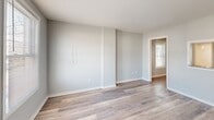 Located at 1603 Roane St in Richmond, VA, this well-appointed one-bedroom, one-bathroom unit offers a thoughtfully designed single-level layout. Light-toned hardwood flooring runs consistently throughout the space, creating a clean and cohesive aesthetic complemented by soft gray walls and crisp white trim.

The open kitchen and living area serves as the heart of the unit. The kitchen is equipped with a full suite of stainless steel appliances, including a refrigerator, range, microwave, and dishwasher. White shaker-style cabinetry pairs elegantly with granite countertops, and a window above the sink allows natural light to brighten the workspace.

The bedroom is a comfortable, well-lit retreat featuring two windows that invite ample natural light and provide views of the surrounding area. A closet offers practical storage, and the neutral color palette keeps the room feeling open and airy.

The bathroom is clean and functional, featuring a full tub-shower combination with a curtain rod, alongside wood-look flooring that ties in with the rest of the unit.

Throughout the space, the design prioritizes simplicity and functionality, with consistent finishes and an abundance of natural light making this Richmond unit a practical and attractive place to call home.