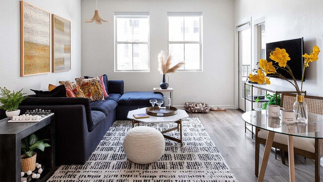 Apartment living room with wood-style flooring. - Griffis Mission Valley